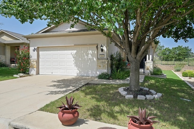 view of front of property featuring a garage and a front yard