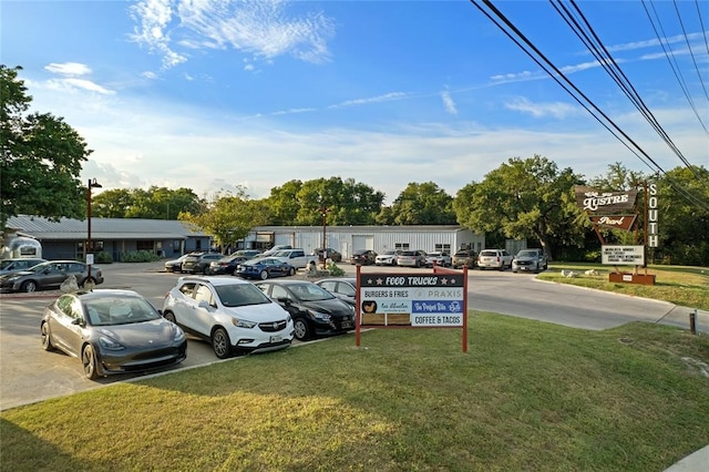 view of parking featuring a yard