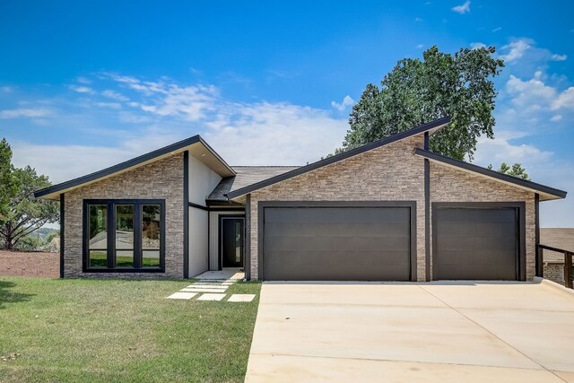 view of front of home with a front lawn and a garage