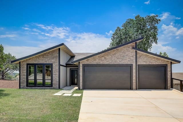 view of front of house featuring a garage and a front lawn