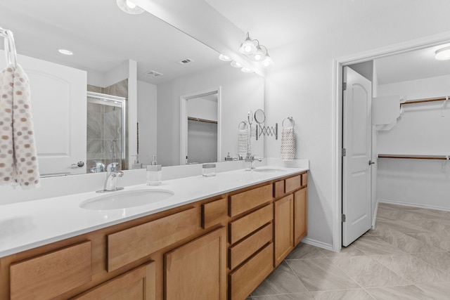 bathroom featuring tile patterned flooring, vanity, and an enclosed shower