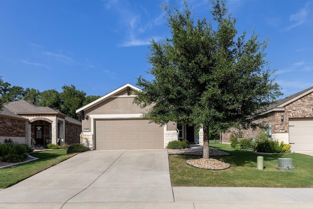 view of front of home with a garage and a front lawn