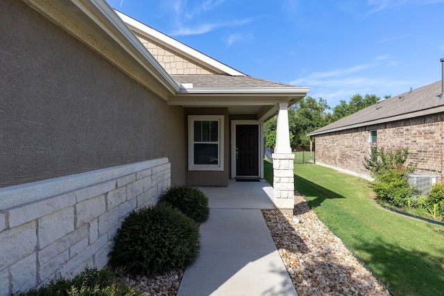 doorway to property with a lawn