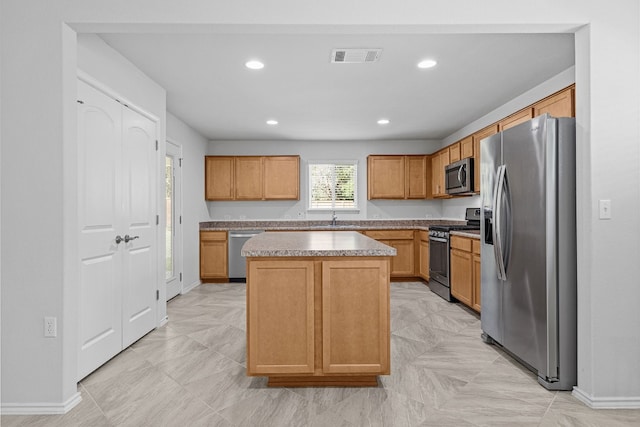 kitchen featuring sink, a kitchen island, and stainless steel appliances