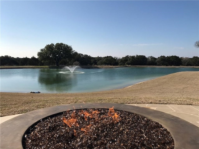 view of water feature with an outdoor fire pit