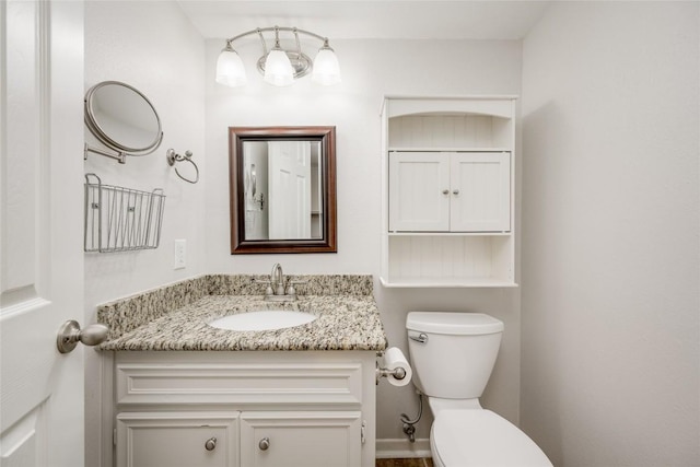 half bathroom with toilet and vanity