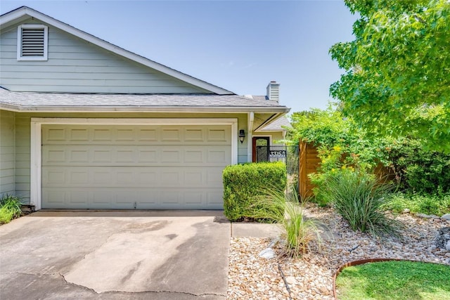 view of front of property with driveway and a shingled roof