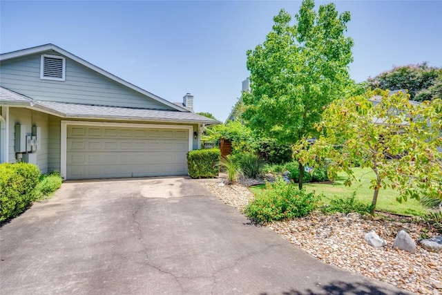 3315 W William Cannon Dr Unit A, Austin, TX 78745 - view of front of house with driveway, a garage, a chimney, and a shingled roof