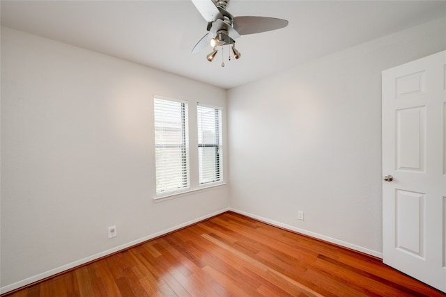 spare room with wood-type flooring and ceiling fan