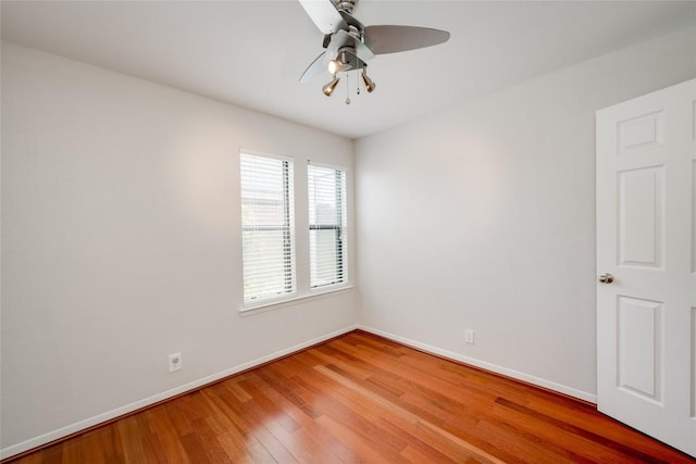 unfurnished room with a ceiling fan, baseboards, and light wood finished floors