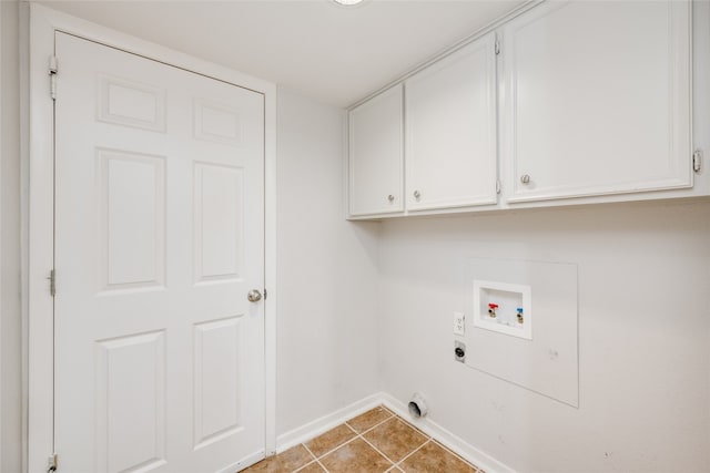 clothes washing area featuring cabinets, tile patterned flooring, hookup for a washing machine, and electric dryer hookup