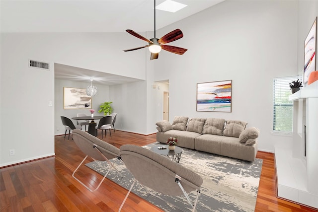 living room with ceiling fan, wood-type flooring, and high vaulted ceiling