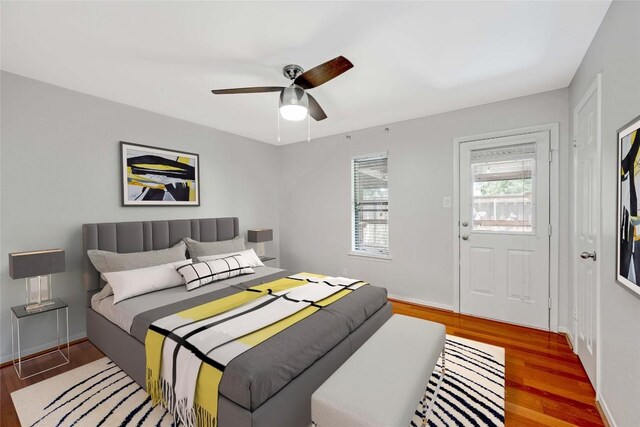 bedroom with dark hardwood / wood-style floors and ceiling fan