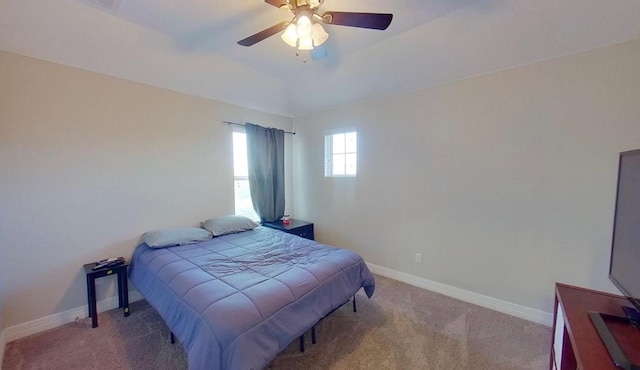 carpeted bedroom featuring lofted ceiling, ceiling fan, and baseboards