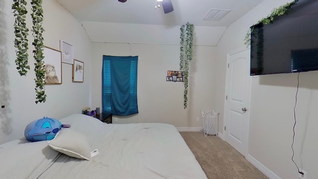 carpeted bedroom with vaulted ceiling and ceiling fan