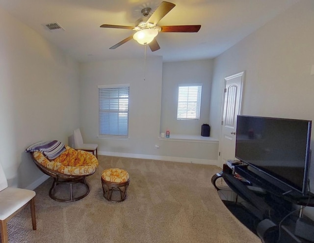 sitting room with ceiling fan and carpet floors