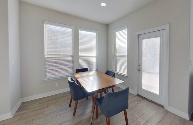 dining room featuring light wood-style floors and baseboards