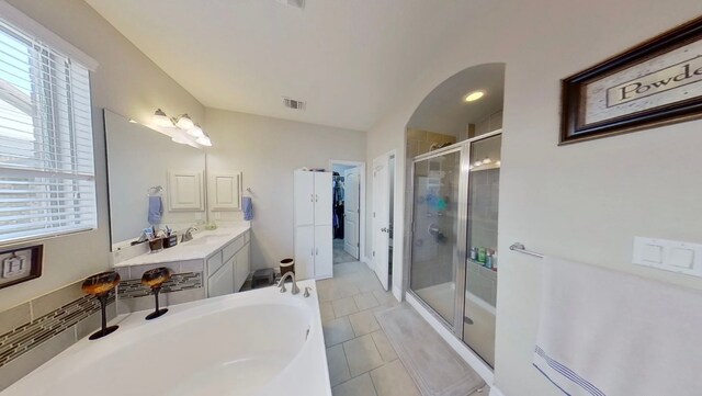 bathroom with tile patterned flooring, vanity, and separate shower and tub