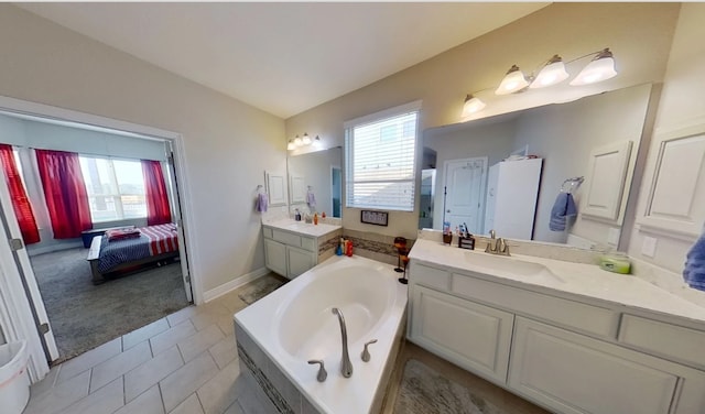 bathroom with vanity, tile patterned floors, and a washtub