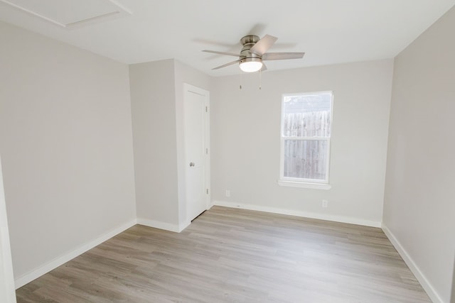 spare room featuring light wood-type flooring and ceiling fan