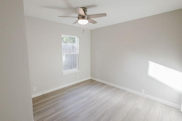 empty room with light hardwood / wood-style flooring and ceiling fan