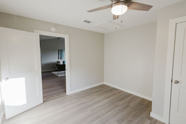 empty room with light wood-type flooring and ceiling fan