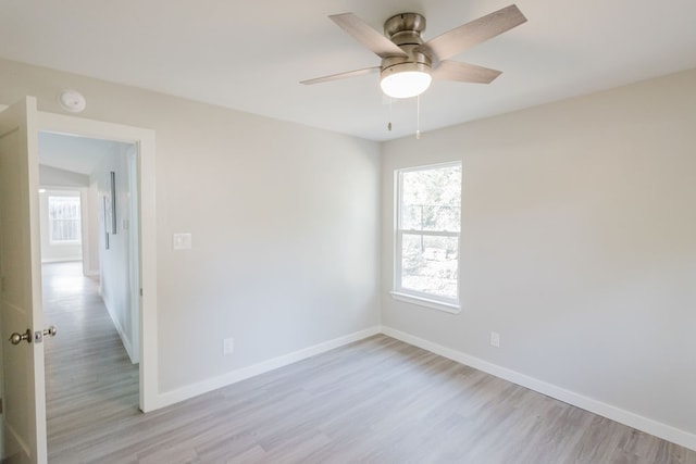 empty room with light hardwood / wood-style flooring and ceiling fan