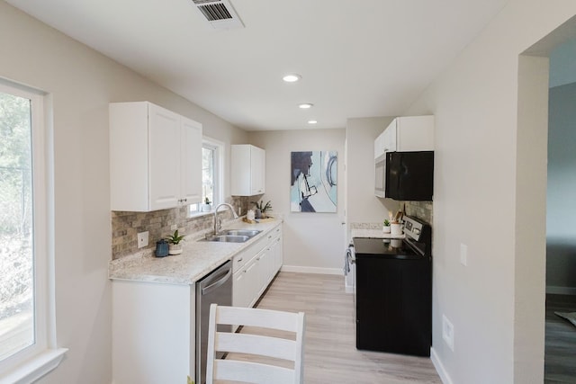 kitchen with range, dishwasher, decorative backsplash, and light wood-type flooring