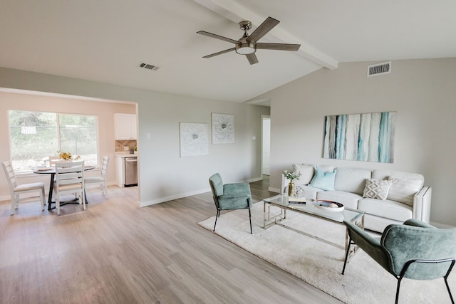 living room with vaulted ceiling with beams, ceiling fan, and light hardwood / wood-style floors