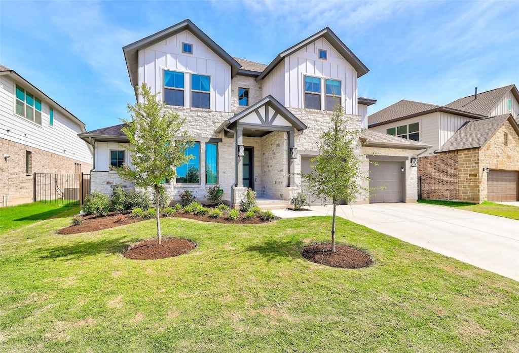 view of front of property featuring a garage and a front lawn