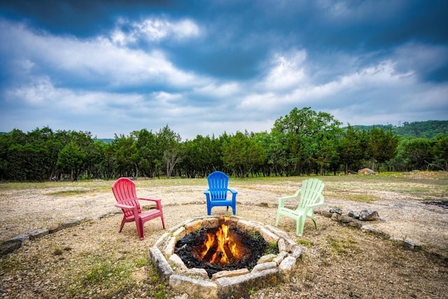 7610 Ramble Rdg, San Antonio, TX 78266 - view of yard featuring an outdoor fire pit and a forest view
