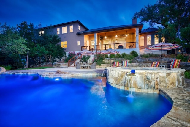 7610 Ramble Rdg, San Antonio, TX 78266 - pool at night with stairs, a pool with connected hot tub, a patio, and a ceiling fan