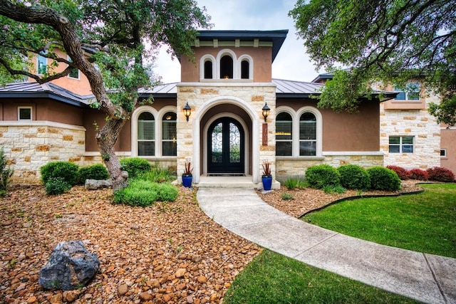 7610 Ramble Rdg, San Antonio, TX 78266 - doorway to property featuring a standing seam roof, stucco siding, stone siding, french doors, and a metal roof