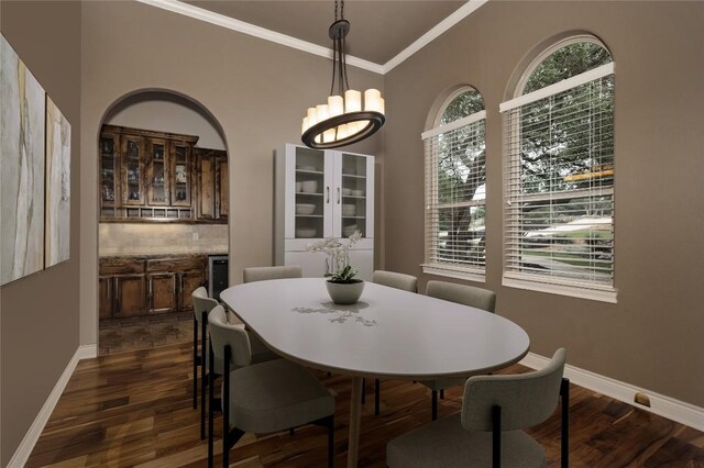 dining room with crown molding, a chandelier, and dark hardwood / wood-style floors