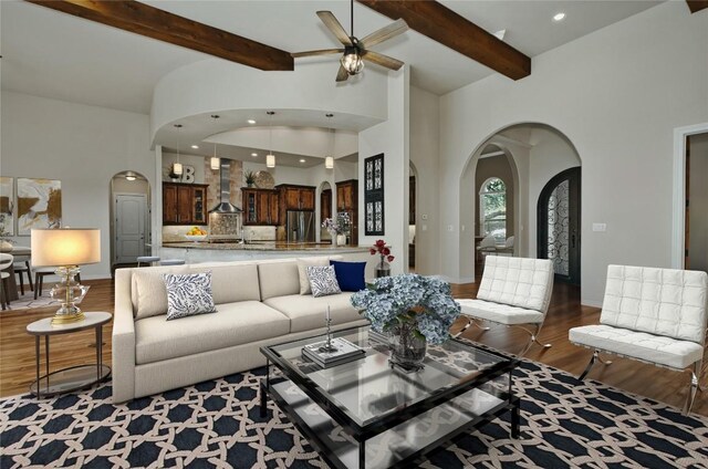 living room with ceiling fan, high vaulted ceiling, and hardwood / wood-style floors