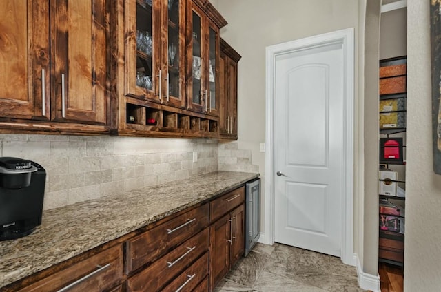 7610 Ramble Rdg, San Antonio, TX 78266 - kitchen with light stone counters, backsplash, wine cooler, and glass insert cabinets