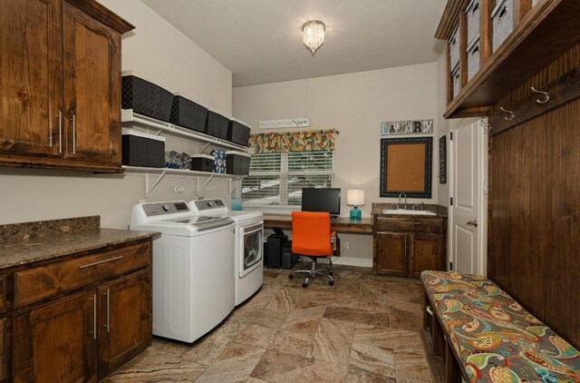 laundry room with light tile patterned floors, sink, washing machine and clothes dryer, and cabinets