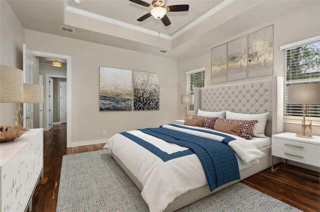 bedroom featuring dark hardwood / wood-style flooring, a raised ceiling, and ceiling fan