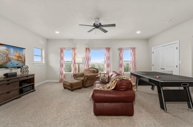 recreation room with ceiling fan and carpet