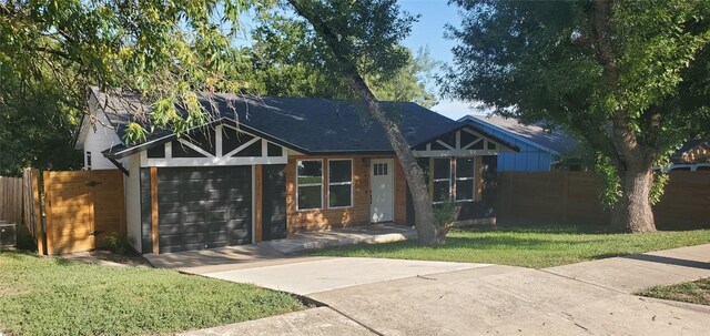 view of front of property featuring a garage and a front lawn