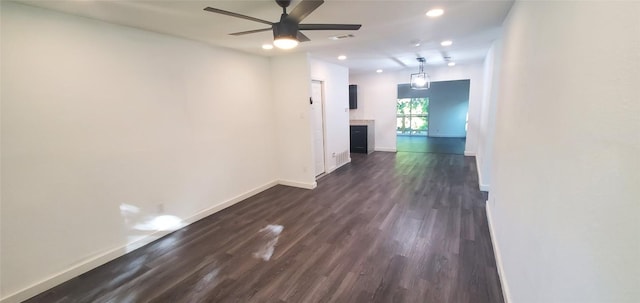 empty room featuring ceiling fan, recessed lighting, visible vents, baseboards, and dark wood finished floors