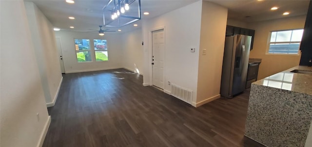 hallway with dark wood-style floors, baseboards, and recessed lighting