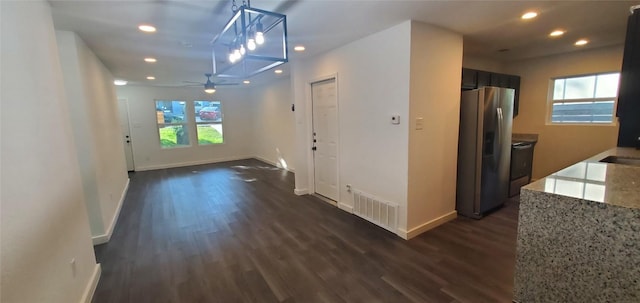 hall with dark wood-style floors, baseboards, visible vents, and recessed lighting