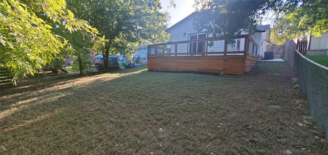 rear view of property featuring a yard and a deck