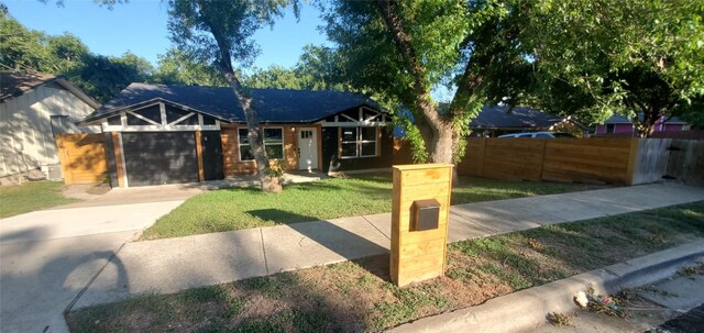 view of front facade with a garage and a front lawn