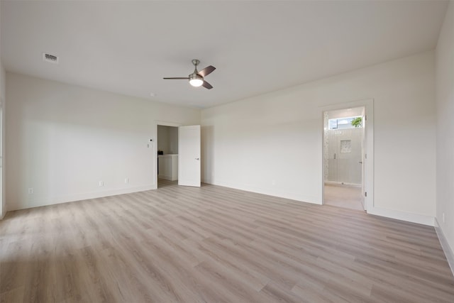 empty room with light hardwood / wood-style floors and ceiling fan