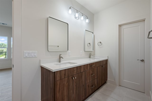 bathroom with dual vanity and tile patterned floors