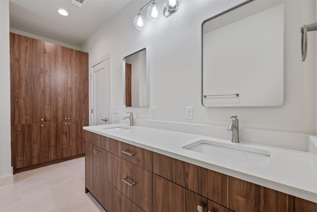 bathroom featuring tile patterned flooring and dual bowl vanity