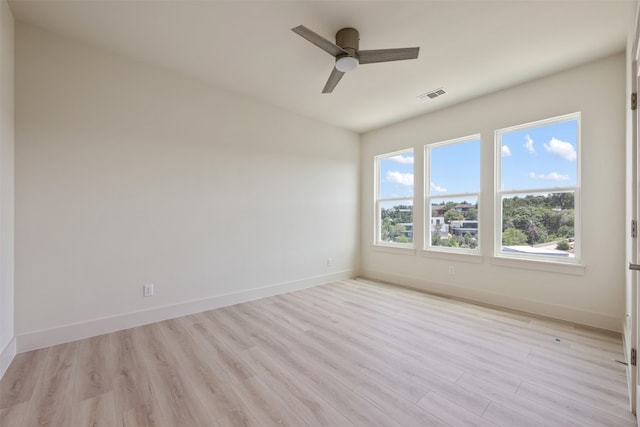 empty room featuring ceiling fan and light hardwood / wood-style flooring