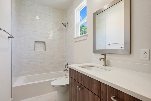 full bathroom with toilet, vanity, and tiled shower / bath